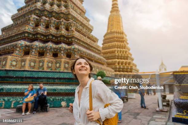 woman exploring  wat pho in bangkok - gap year stock pictures, royalty-free photos & images