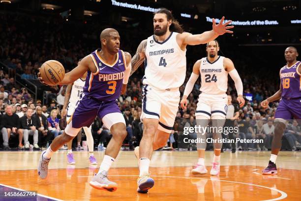 Chris Paul of the Phoenix Suns looks to pass around Steven Adams of the Memphis Grizzlies during the first half of the NBA game at Footprint Center...