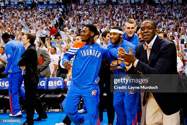 Oklahoma City Thunder players, from left, Royal Ivey, Lazar Hayward, Cole Aldrich and Reggie Jackson celebrate after their team defeated the San...