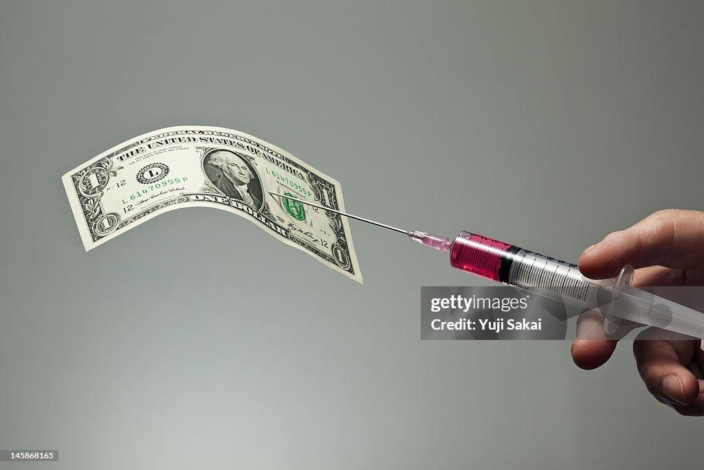 US dollar with syringe