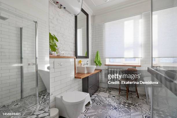 bathroom interior in white color with mirror washbasin toilet bowl bath and shower cabin with window - tiled floor stock photos et images de collection