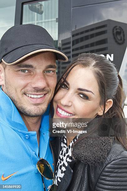 Wesley Sneijder and partner Yolanthe Cabau van Kasbergen at Schiphol Airport where the Dutch soccer players bid farewell to their spouses and...
