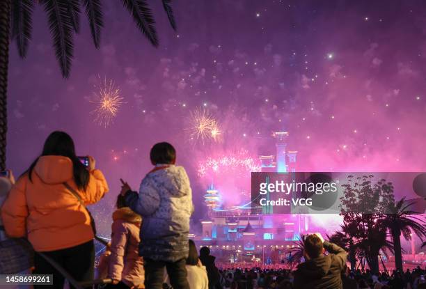 People watch fireworks at the OCT Fabland tourist resort to celebrate the Spring Festival on January 22, 2023 in Xiangyang, Hubei Province of China....