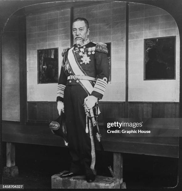 Japanese naval officer, Marshal-Admiral Marquis Togo Heihachiro in full ceremonial uniform, with his sword by his side, at his home in Tokyo, Japan,...