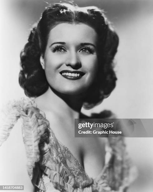 American opera singer Nan Merriman , wearing an outfit with a sweetheart neckline, against a white background, in a publicity portrait, United...