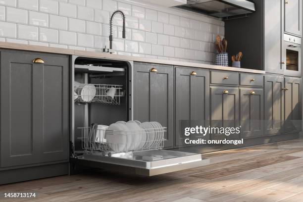 close-up view of open dishwasher with kitchen utensils in it - máquina de lavar louça imagens e fotografias de stock