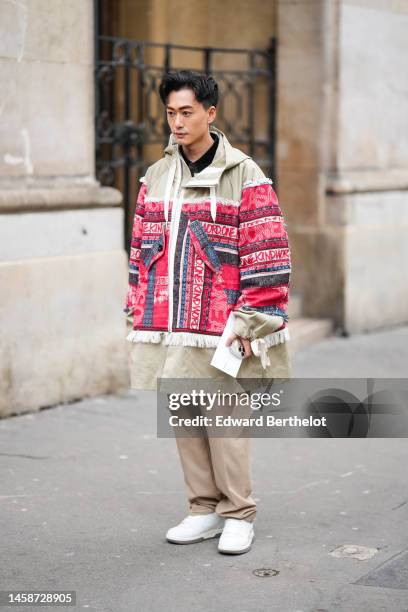 Guest wears a black shirt, a beige with embroidered red / blue / gray wool pattern fringed oversized zipper coat, beige suit pants, white matte...