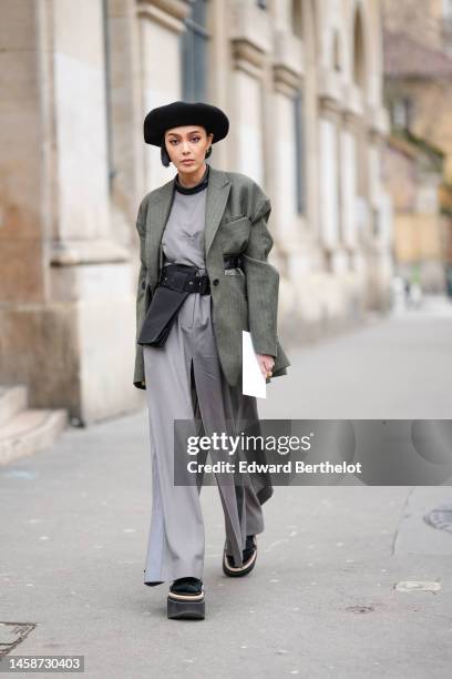 Guest wears a black felt wool beret, a black t-shirt, a pale gray slit / split long dress, a dark gray striped print pattern blazer jacket, a black...