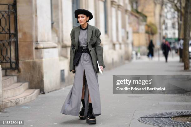 Guest wears a black felt wool beret, a black t-shirt, a pale gray slit / split long dress, a dark gray striped print pattern blazer jacket, a black...