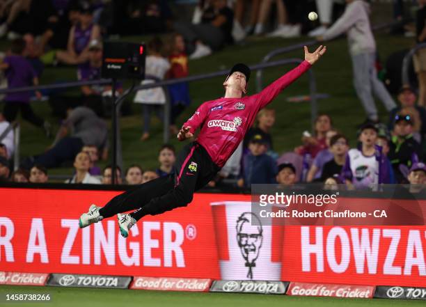 Jordan Silk of the Sixers attempts to take a catch during the Men's Big Bash League match between the Hobart Hurricanes and the Sydney Sixers at...