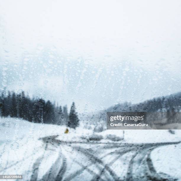 window condensation against winter landscape covering the driveway - extreme weather stock pictures, royalty-free photos & images