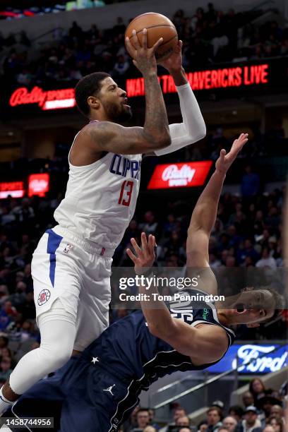 Paul George of the LA Clippers drives to the basket against Dwight Powell of the Dallas Mavericks in the third quarter at American Airlines Center on...