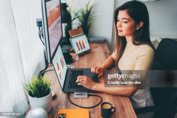 woman working at home talks to virtual assistant - alexa martin stock pictures, royalty-free photos & images