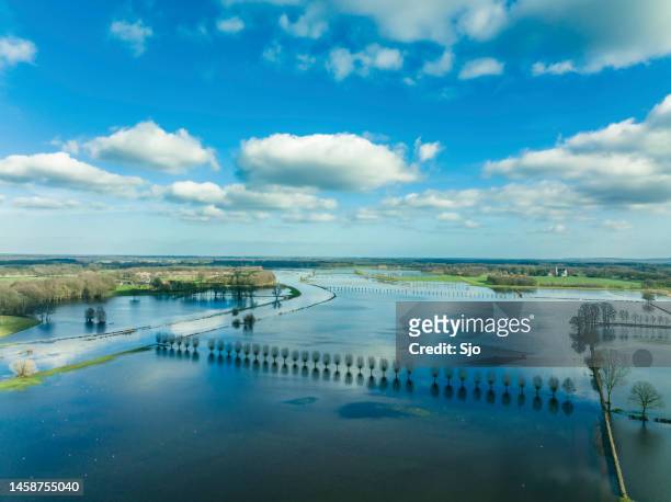 vecht river high water level flooding at the vilsteren weir drone view - riverbank stockfoto's en -beelden