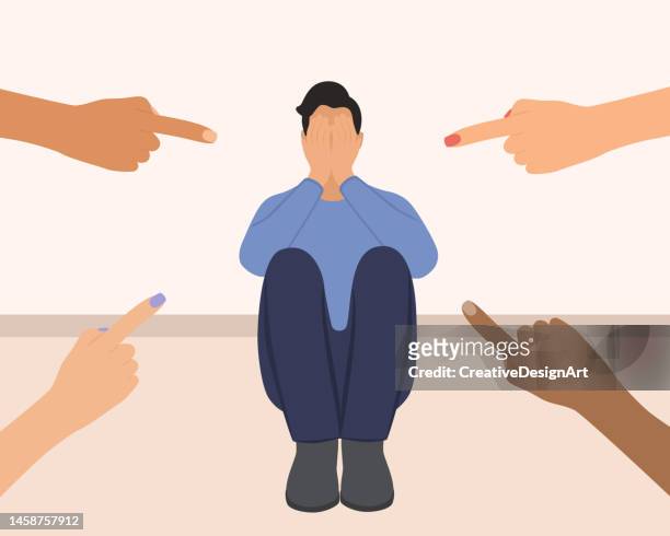 depressed man surrounded by hands with index fingers pointing at him. sad man covering his face with his hands. victim blaming and social judgement concept - unfairness stock illustrations
