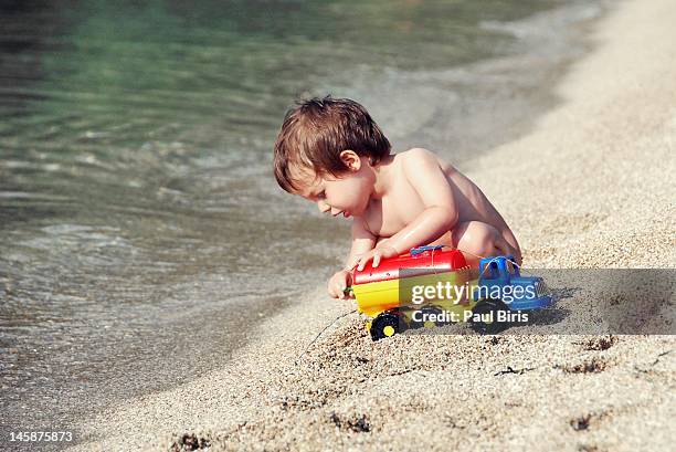 playing on beach - toy truck stock pictures, royalty-free photos & images