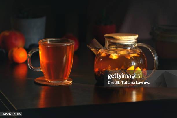 cup of fruit tea with transparent glass teapot. life style cozy home interior photo. morning refreshment concept, still life - cosy autumn stock pictures, royalty-free photos & images