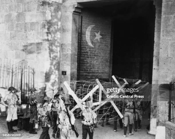 Barbed wire 'knife-rest' barriers being carried through the Damascus Gate in Jerusalem during the operation to recapture the Old City from Arab...