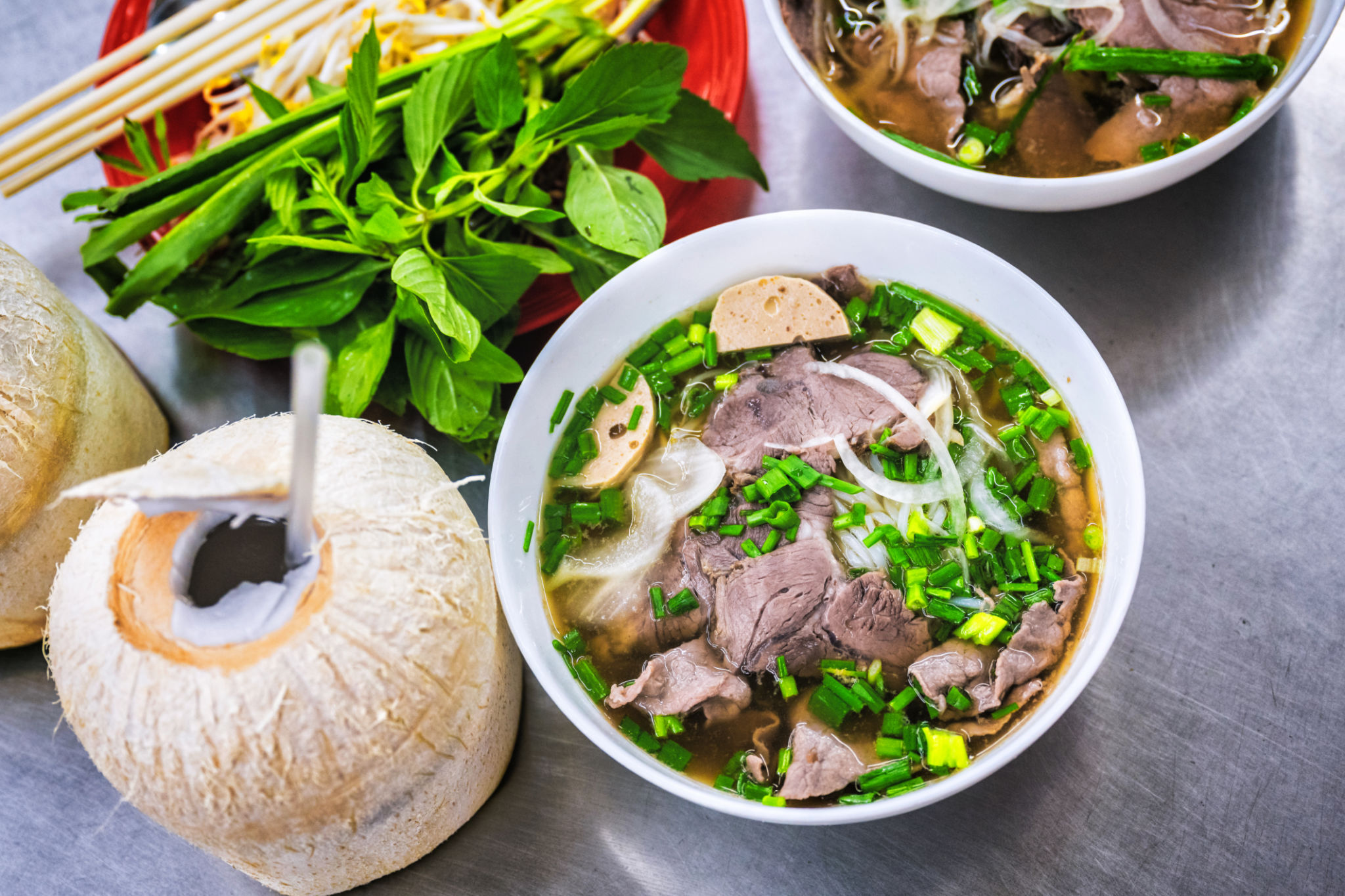 bowl of pho soup on metal table bowl of pho soup on metal table