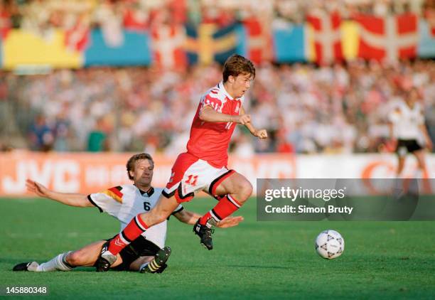 Brian Laudrup of Denmark takes the ball past Guido Buchwald of Germany during the UEFA European Championships 1992 Final between Denmark and Germany...