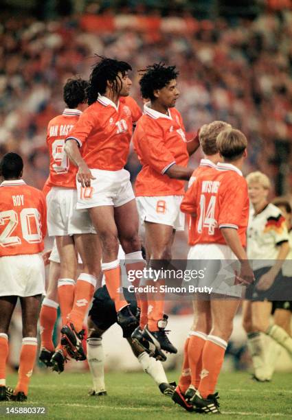 The AC Milan contingent of Ruud Gullit, Frank Rijkaard and Marco van Basten of Netherlands line up to defend a free kick during the UEFA European...