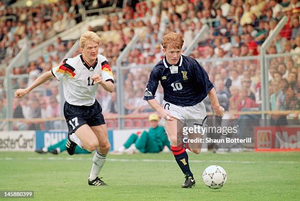 Stuart McCall of Scotland takes the ball past Stefan Effenberg of Germany during the UEFA European Championships 1992 Group 2 match between Scotland...