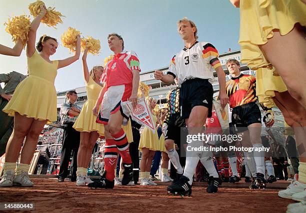 Lars Olsen of Denmark and Andreas Brehme of Germany lead their sides out prior to the UEFA European Championships 1992 Final between Denmark and...