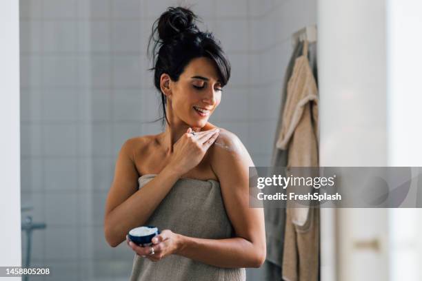 a happy beautiful woman relaxing after taking a shower - beautiful woman bath stockfoto's en -beelden