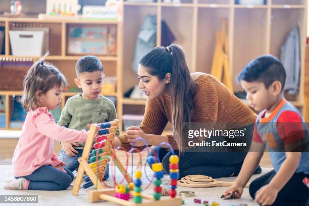 learning through play - child care stockfoto's en -beelden
