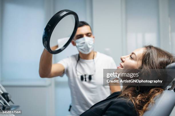 at the dentist's. - dentist's chair stock pictures, royalty-free photos & images