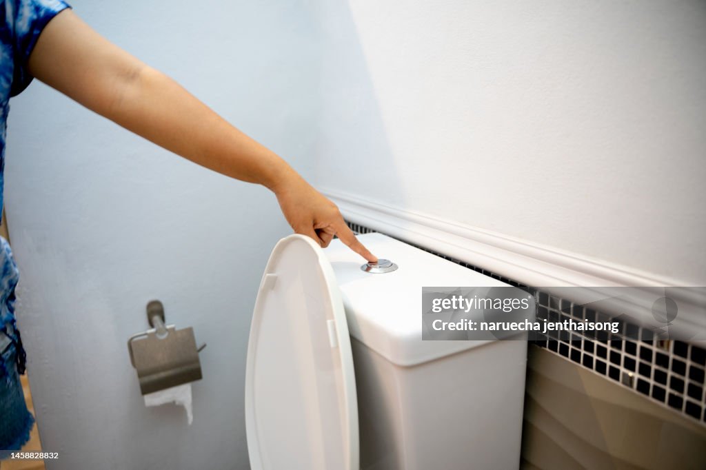 Cropped Hand Of Man Flushing Water
