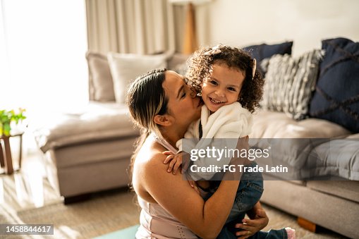 Portrait of toddler girl having fun with her mother in the living room at home Portrait of toddler girl having fun with her mother in the living room at home