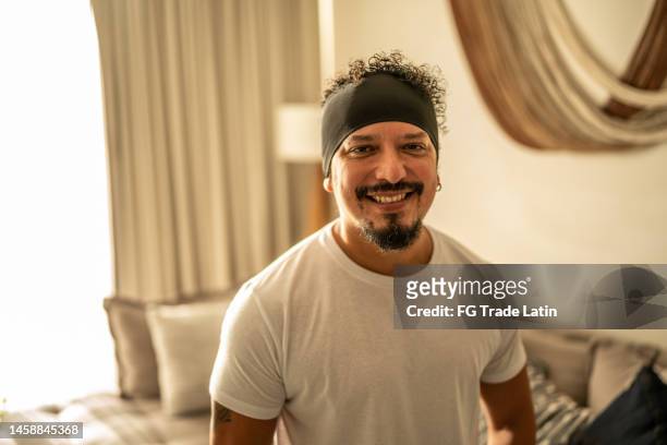 portrait of mid adult man in the living room at home - goatee stock pictures, royalty-free photos & images