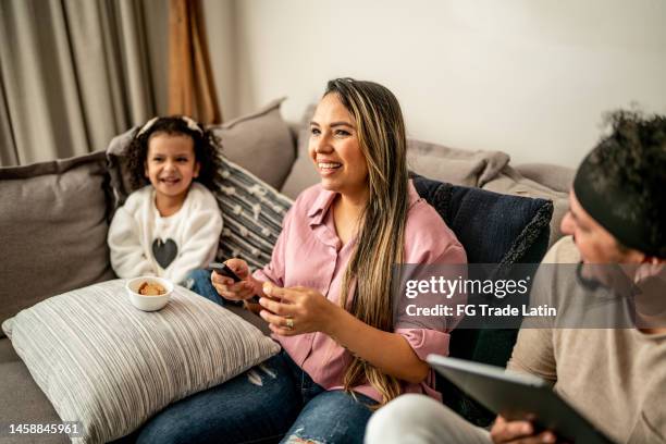 mère et fille s’amusent en regardant la télévision dans le salon à la maison - movie film reel photos et images de collection