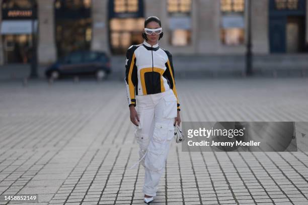 Sabina Jakubowicz seen wearing white Coperni shades, white / black / yellow Dior leather biker jacket and silver mini bag, The Attico white wide leg...