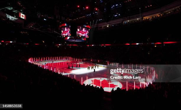 The Canadian flag is projected onto the ice prior to the start of NHL action between the Vancouver Canucks and the Edmonton Oilers on January 2023 at...