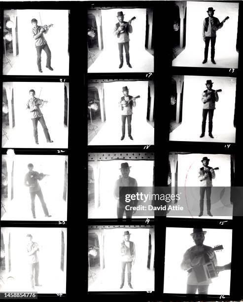 The photographer's original vintage contact sheets of Rick Danko and Levon Helm of the roots rock group The Band playing violin and mandolin and...