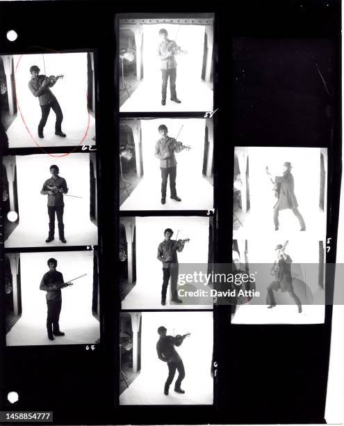 The photographer's original vintage contact sheets of Rick Danko and Levon Helm of the roots rock group The Band, playing violin and guitar as they...