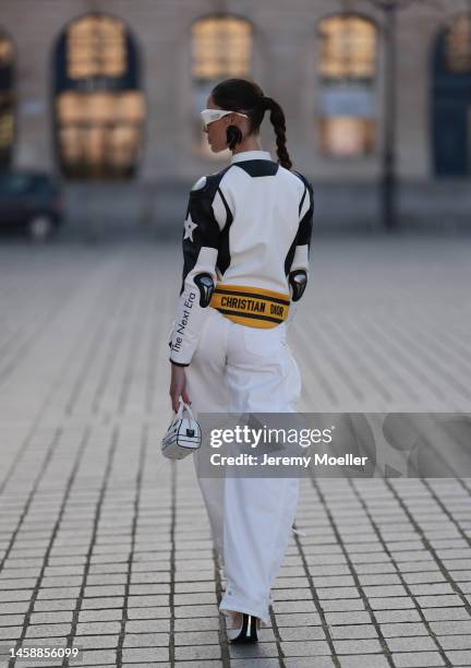 Sabina Jakubowicz seen wearing white Coperni shades, white / black / yellow Dior leather biker jacket and silver mini bag, The Attico white wide leg...