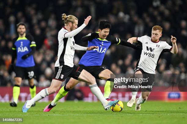 Son Heung-Min of Tottenham Hotspur from a bunker Tim Ream and Harrison Reed of Fulham during the Premier League match between Fulham FC and Tottenham...