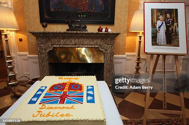 Cake in honor of the British Queen's Diamond Jubilee sits on a table at a garden party at the British Ambassador to Germany's official residence on...