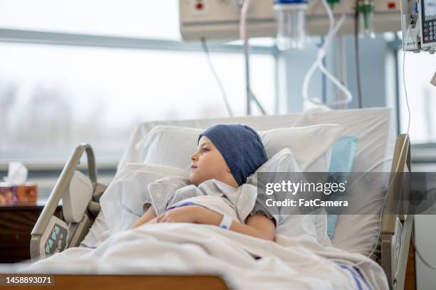 young oncology patient in the hospital - child in hospital bed stock pictures, royalty-free photos & images