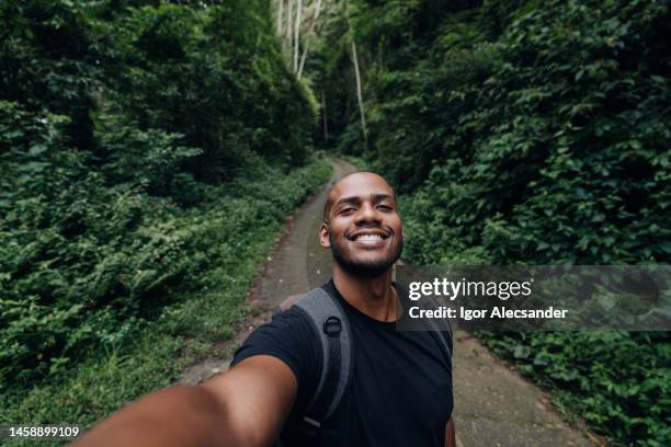 backpacker taking a selfie on the forest trail - selfie stock pictures, royalty-free photos & images
