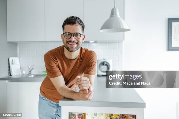 portrait of a handsome young man looking at camera - leaning on elbows stock pictures, royalty-free photos & images