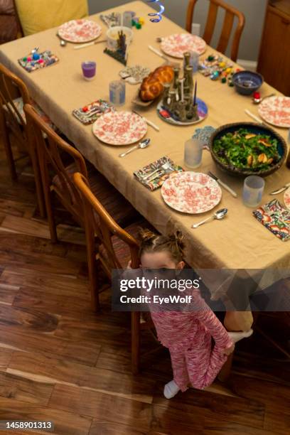 high angle view of toddler setting table for hanukkah dinner celebration - challah stock pictures, royalty-free photos & images