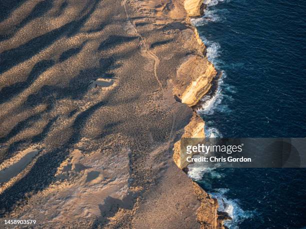 aerial view of rocky coastline - dark ocean ripples stockfoto's en -beelden