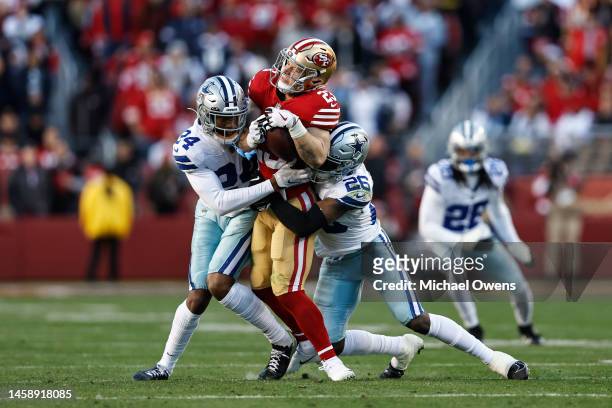 Christian McCaffrey of the San Francisco 49ers is tackled by Israel Mukuamu of the Dallas Cowboys and DaRon Bland of the Dallas Cowboys during an NFL...
