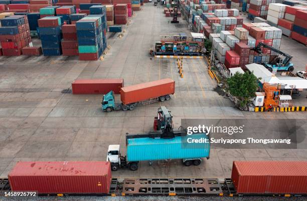 forklift handling container loading to freight train for business logistics, import export shipping or freight transportation. - shipyard aerial stock pictures, royalty-free photos & images