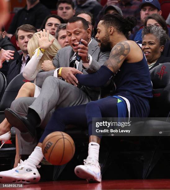 Angelo Russell of the Minnesota Timberwolves collides with former New York Yankee Alex Rodriguez court side going for a loose ball during the second...