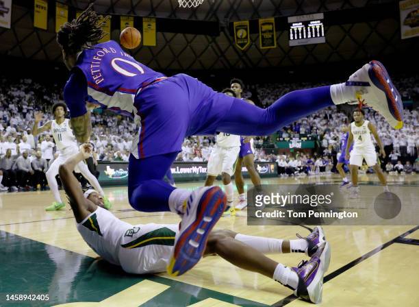 Bobby Pettiford Jr. #0 of the Kansas Jayhawks passes the ball after colliding with Flo Thamba of the Baylor Bears in the first half at Ferrell Center...